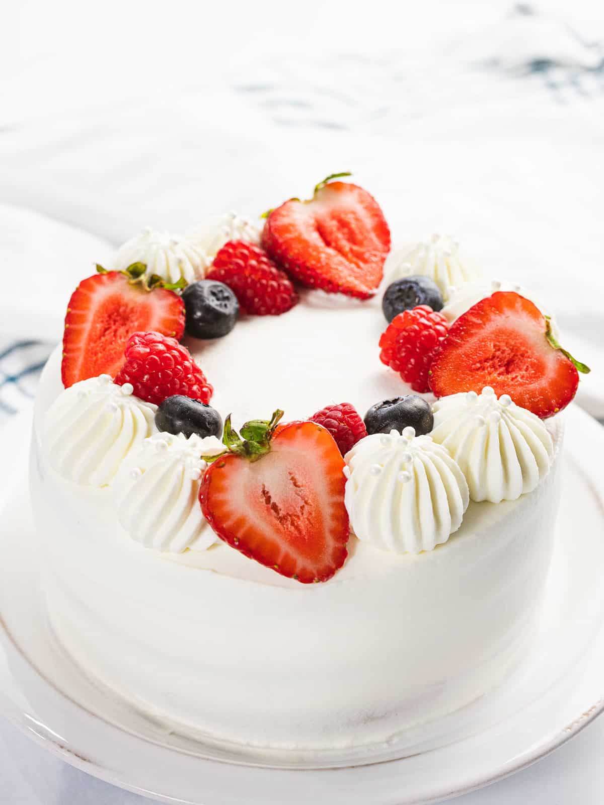 Berry Chantilly cake with fresh strawberries, blueberries, and raspberries.