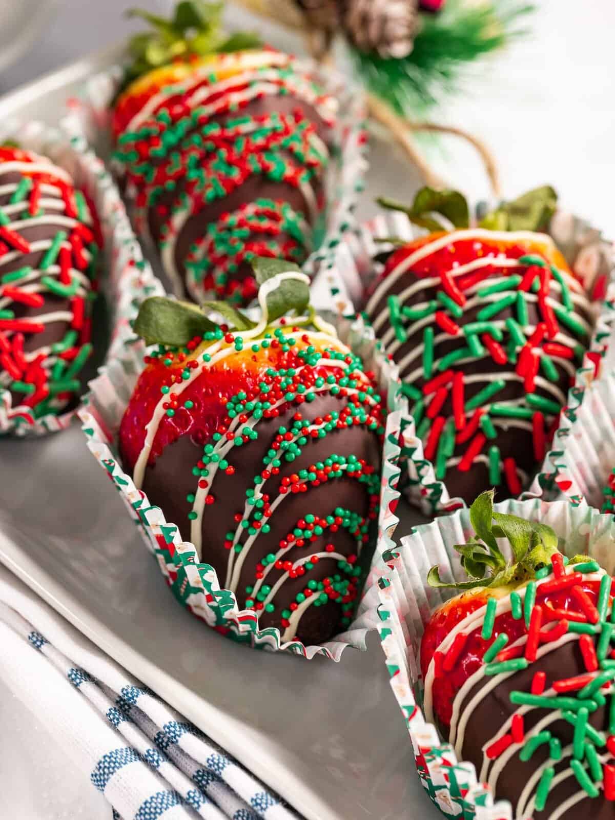 Christmas chocolate-covered strawberries with festive red and green sprinkles.