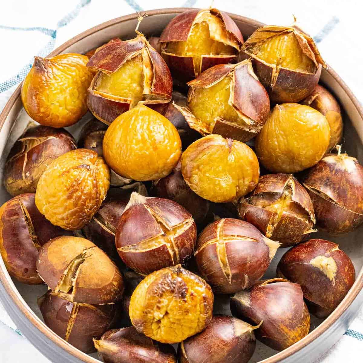 Roasted chestnuts with outer shell peeled back.