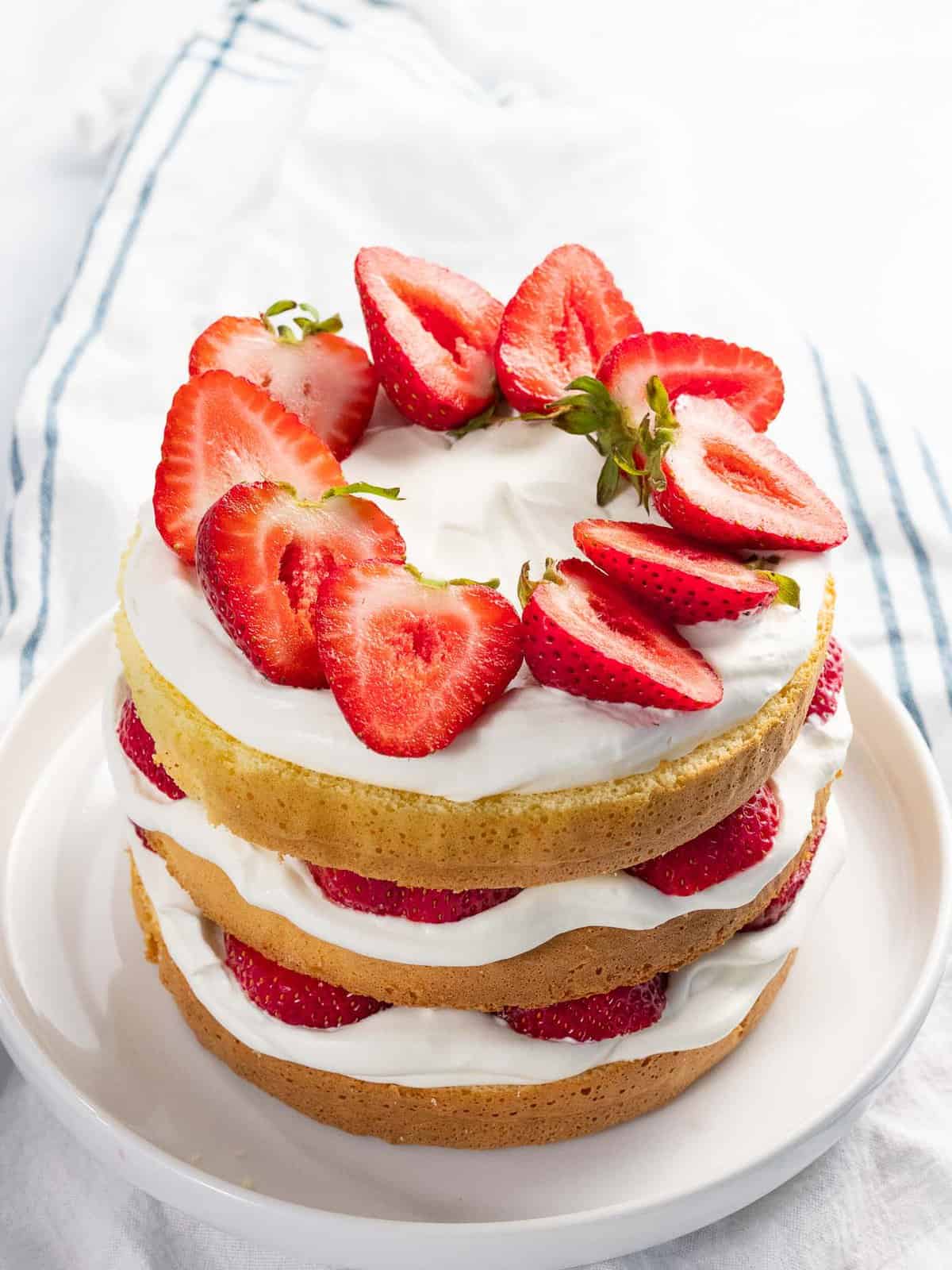 Fresh strawberry cake layered with whipped cream and vanilla cake.