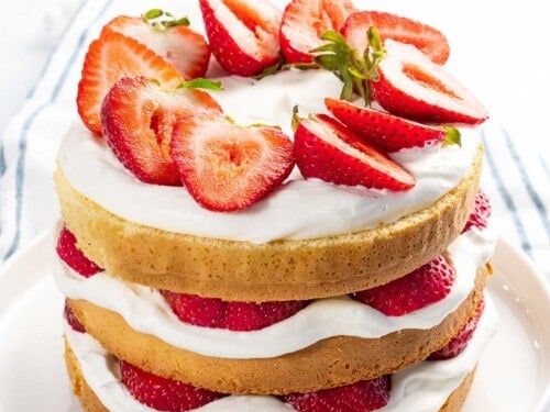 Strawberry cake with fresh strawberries and whipped cream.