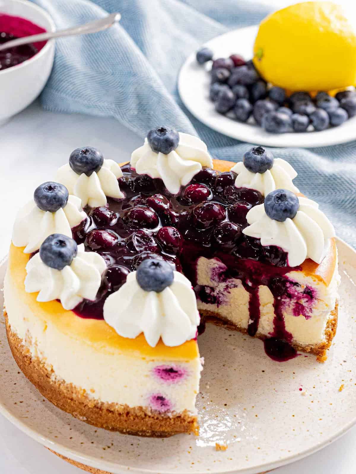 Blueberry cheesecake made with fresh blueberries and topped with blueberry sauce.