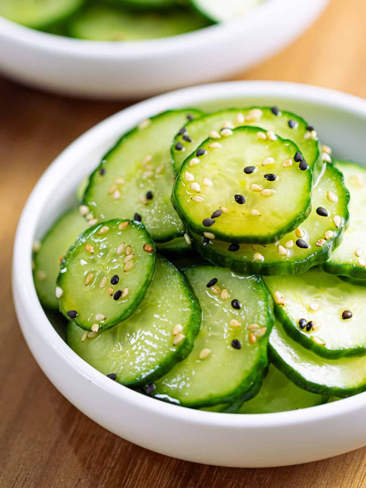 Sunomono or Japanese cucumber salad in a white bowl.