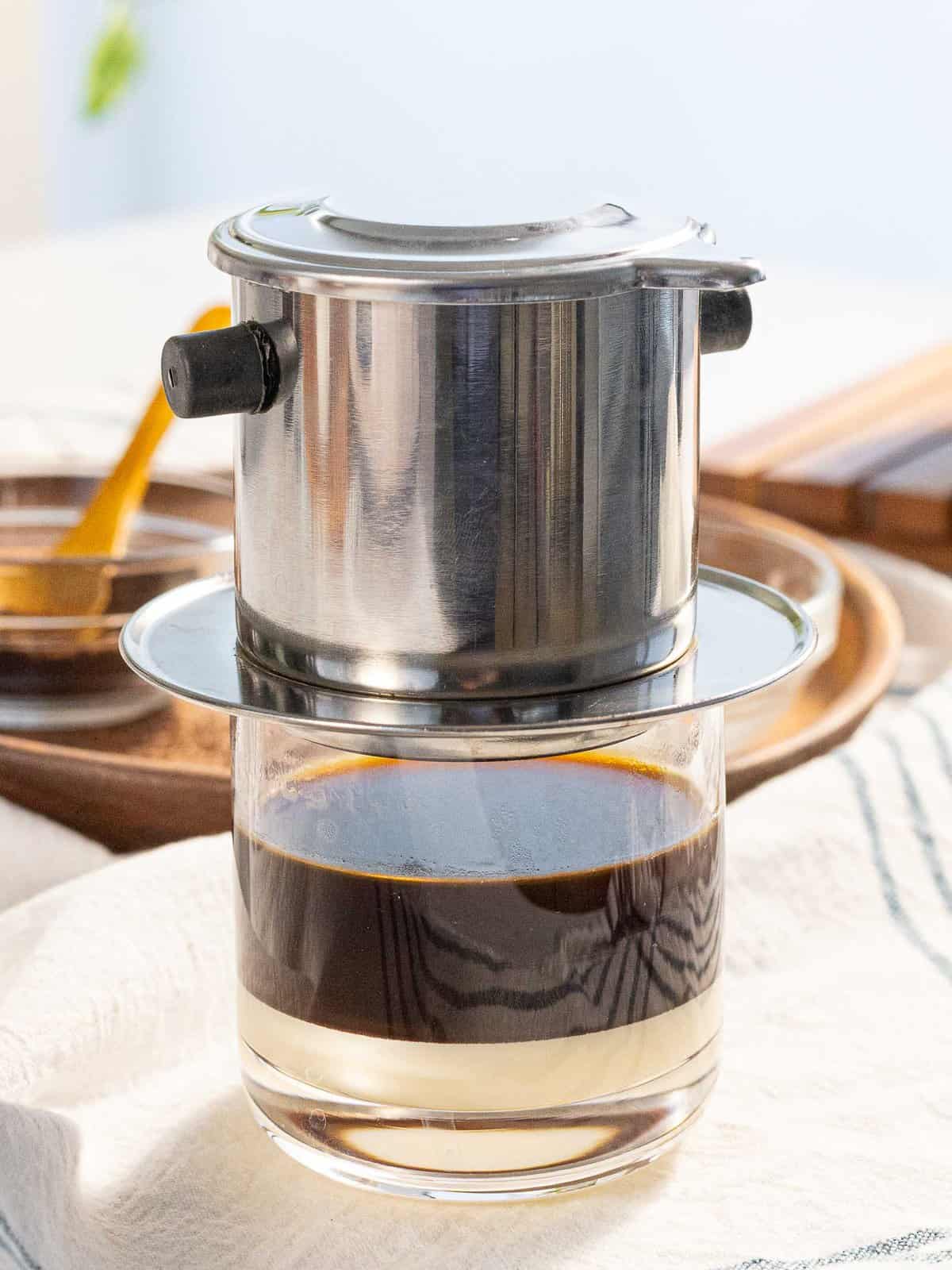 Vietnamese coffee is slowly brewed with a phin filter.